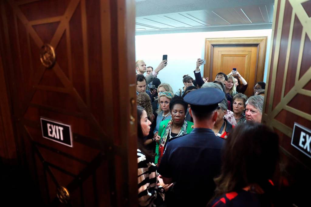 Guests wait to enter the Senate Judiciary Committee on Capitol Hill in Washington on Friday. (AP Photo/Andrew Harnik)