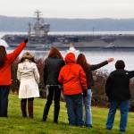 People greeted the aircraft carrier USS Nimitz when it returned to Naval Station Everett on Dec. 16, 2013. (Dan Bates / Herald file)