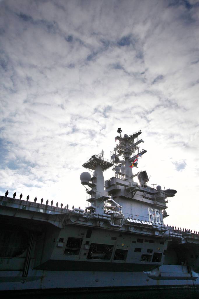 USS Nimitz personnel line the deck of the aircraft carrier as it entered the Port of Everett on Dec. 16, 2013. (Genna Martin / Herald file)