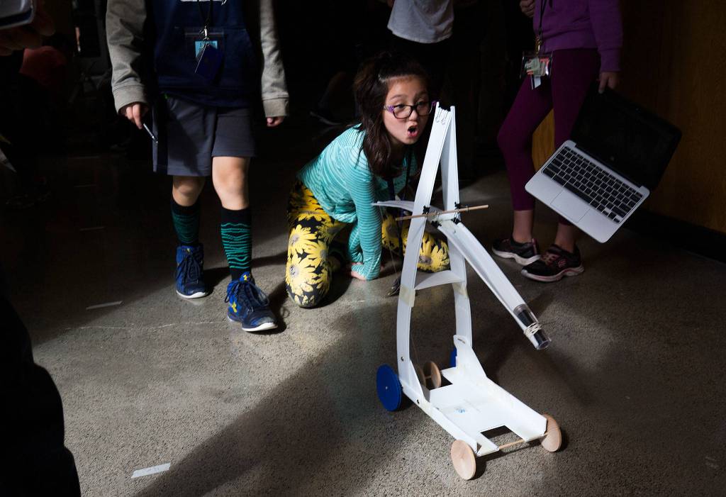 Marshall Elementary fifth-grader Talia Gibbs reacts as her teams gravity car goes farther than previous attempts during a one-week engineering program at the University of Washington on Sept. 12 in Seattle. (Andy Bronson / The Herald)