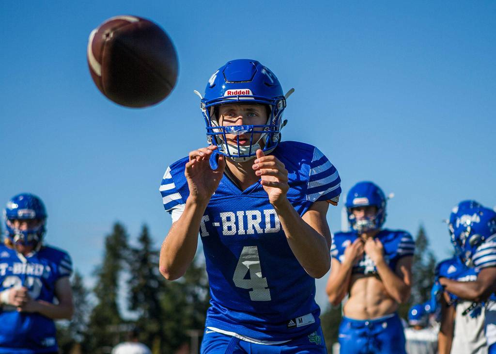 Shorewood quarterback David Snell takes a snap during football practice on Sept. 19 in Shoreline. (Olivia Vanni / The Herald)
