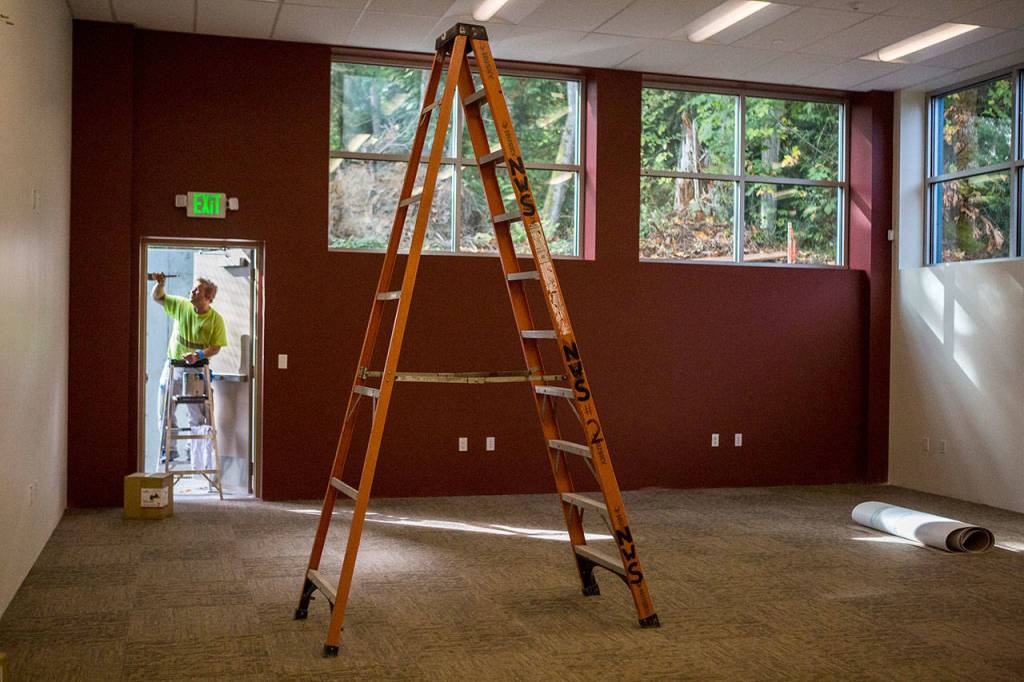 A painter puts the finishing touches in the teen room at the new Mukilteo Boys Girls Club. (Olivia Vanni / The Herald)