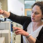 Lori Robins places a solid phase micro extraction fiber in a mass spectrometer. (Olivia Vanni / The Herald)
