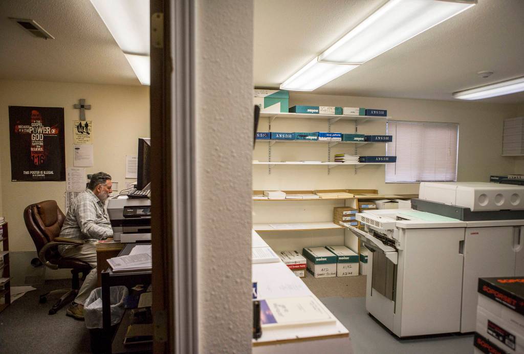Olivia Vanni / The Herald                                 Woode Brinkerhoff sits in his office next to the SonShine Societys printer in Everett on Sept. 26.