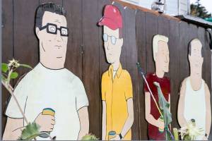Kelly Hatley, 63, proudly displays characters from King of the Hill in Freeland on Whidbey Island. An artist friend, Linda Frasier, painted the cutouts that are copied from the cartoon series. (Kevin Clark / The Herald)