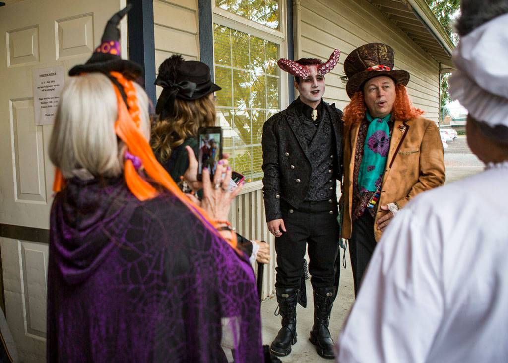 Peter Bakker and his father Peter Bakker stand outside of the Snohomish Community Food Bank before the start of a Halloween-themed wedding Saturday, Oct. 27, in Snohomish. (Olivia Vanni / The Herald)
