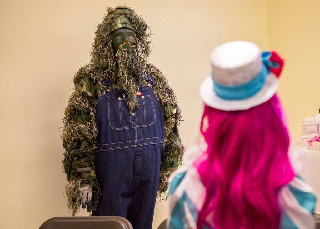 Someone attended the wedding of Kira Day and Peter Bakker dressed as Swamp Thing. Halloween costumes were the dress code for their nuptials Saturday, Oct. 27, at the Snohomish Community Food Bank in Snohomish. (Olivia Vanni / The Herald)