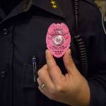 Chief Cheol Kang displays his pink Breast Cancer Awareness badge during the Mukilteo Police Departments Coffee with a Cop on Wednesday in Mukilteo. (Olivia Vanni / The Herald)
