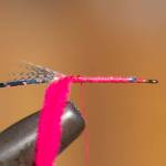 Tie in pieces of chenille and tinsel at bend of hook. Wrap thread back to hook eye. (Mike Benbow photo)