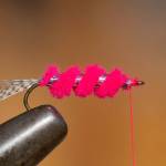 Wrap chenille to behind eye. Secure with three thread wraps and cut waste. Ditto for tinsel. (Mike Benbow photo)