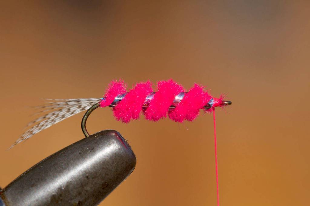 Wrap chenille to behind eye. Secure with three thread wraps and cut waste. Ditto for tinsel. (Mike Benbow photo)