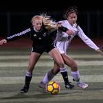 Lake Stevens Callaway Knutson (left) shields her dribble from Jacksons Peyton Manalo during the first half of a Wesco 4A girls soccer match on Oct. 2, 2018, at Lake Stevens High School. The game ended in a scoreless draw after two periods of extra time. (Kevin Clark / The Herald)