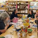 Whidbey Art Escape in Freeland has been the gathering spot every Wednesday night for a group of women who chat, laugh and relax while painting ceramic pottery or creating other art. Owner Tina Beard (left) is selling her business after 15 years. (Patricia Guthrie / Whidbey News Group)