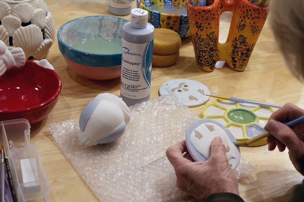 Whidbey Art Escape in Freeland has been the gathering spot every Wednesday night for a group of women who chat, laugh and relax while painting ceramic pottery or creating other art. Owner Tina Beard is selling her business after 15 years. (Patricia Guthrie / Whidbey News Group)