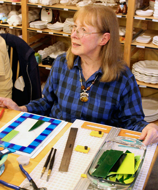 Reece Rose chose to learn how to fuse glass at Whidbey Art Escape where she gathers with other women on Wednesday nights. Here she pieces together the pattern that will be put in a kiln. (Patricia Guthrie / Whidbey News Group)
