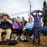 Anabelle Parsons, 6, left, looks up to the sky with binoculars to watch the Vaux Swift fly in during Swift Night Out on Sept. 8, 2018 in Monroe, Wa. Olivia Vanni / The Herald)
