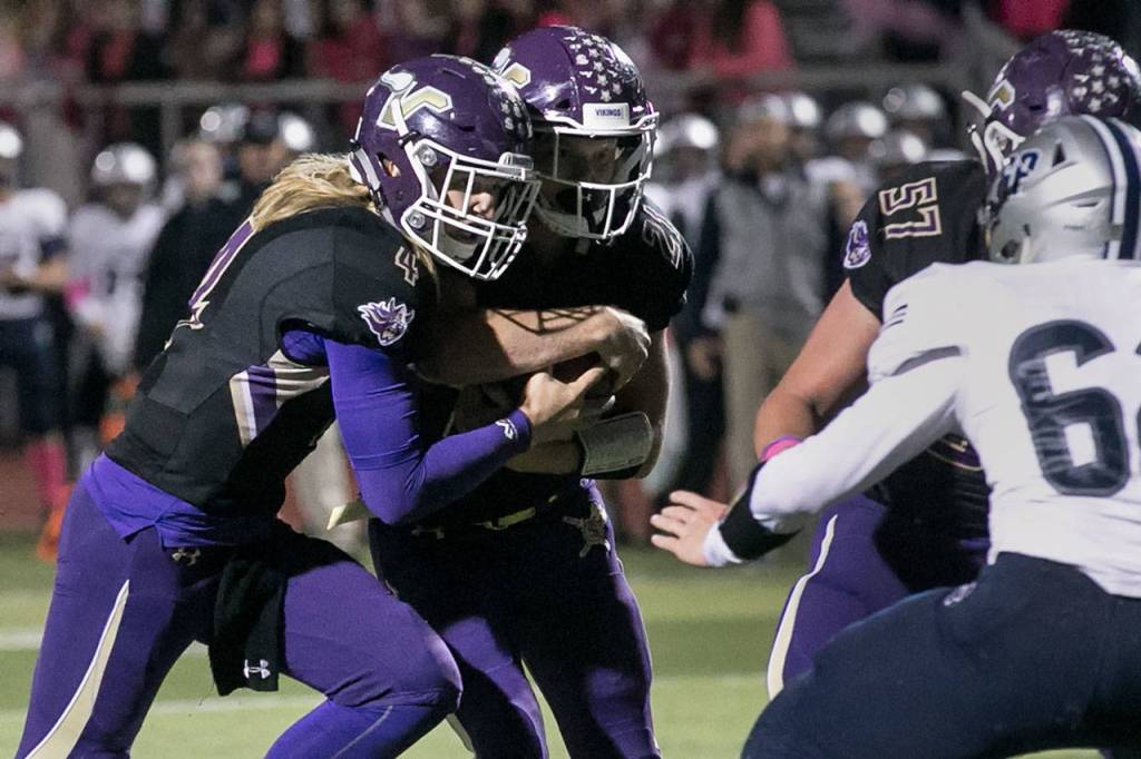 Lake Stevens Tre Long (left) and Jackson Grafe combine to cross the goal line Friday night at Lake Stevens High School on October 5, 2018. (Kevin Clark / The Herald)