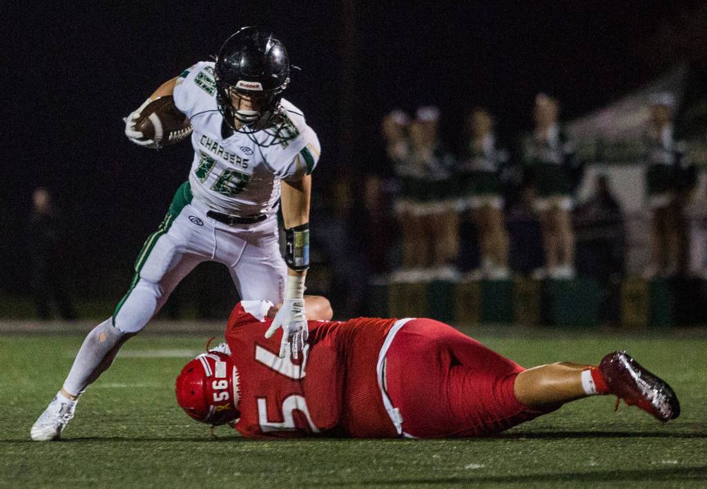 Marysville-Getchells Ryan King is tackled during the game on Oct. 5 in Marysville. (Olivia Vanni / The Herald)
