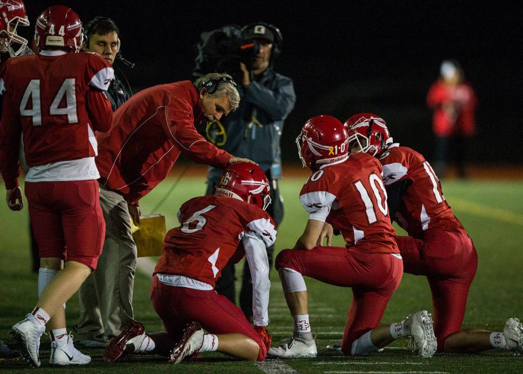 The Marysville Pilchuck sideline congratulates Dillon Kuk after a play during the game on Oct. 5 in Marysville. (Olivia Vanni / The Herald)