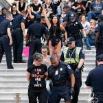 Activists are arrested by Capitol Hill Police officers after occupying the steps on the East Front of the U.S. Capitol as they protest the confirmation vote of Supreme Court nominee Brett Kavanaugh on Capitol Hill on Saturday in Washington. (AP Photo/Alex Brandon)