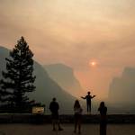 In this July 25 photo, Hannah Whyatt poses for a friends photo as smoke from the Ferguson fire fills Yosemite Valley in Yosemite National Park, California. (AP Photo/Noah Berger, File)
