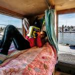On her cozy bed overlooking the Everett Marina, the Everett Yacht Club and boats of all kinds, Arianna reads a Nancy Drew book, The Mystery at Lilac Inn. (Dan Bates / The Herald)