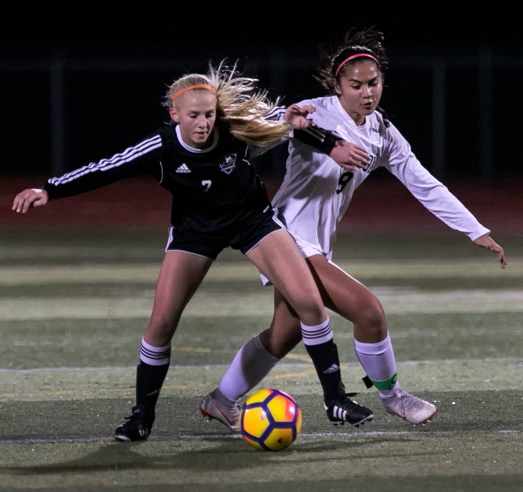 Lake Stevens Callaway Knutson (left) shields her dribble from Jacksons Peyton Manalo at Lake Stevens High School on Oct. 2. (Kevin Clark / The Herald)