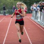 Kings junior Naomi Smith crosses the finish line Saturday during the Hole in the Wall Invitational at Lakewood High School in Arlington. (Olivia Vanni / The Herald)