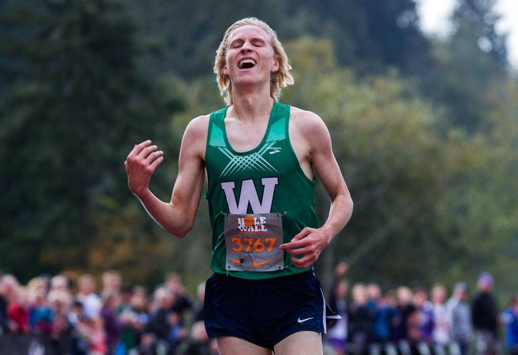 Woodinville senior Luke Houser smiles Saturday after setting a meet record at the Hole in the Wall Invitational at Lakewood High School in Arlington. (Olivia Vanni / The Herald)