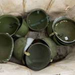 Army helmets sit in a bin at Eds Surplus & Marine in Lynnwood. (Andy Bronson / The Herald)
