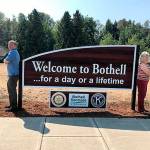 Richard Olson and Susan Gardner bookend the new sign. (Richard Olson)