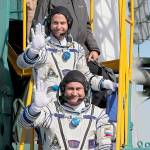 U.S. astronaut Nick Hague (top) and Russian cosmonaut Alexey Ovchinin, crew members of a mission to the International Space Station, wave as they board the rocket prior to the launch of a Soyuz-FG rocket at the Russian-leased Baikonur cosmodrome in Kazakhstan on Thursday. (Yuri Kochetkov, Pool Photo via AP)