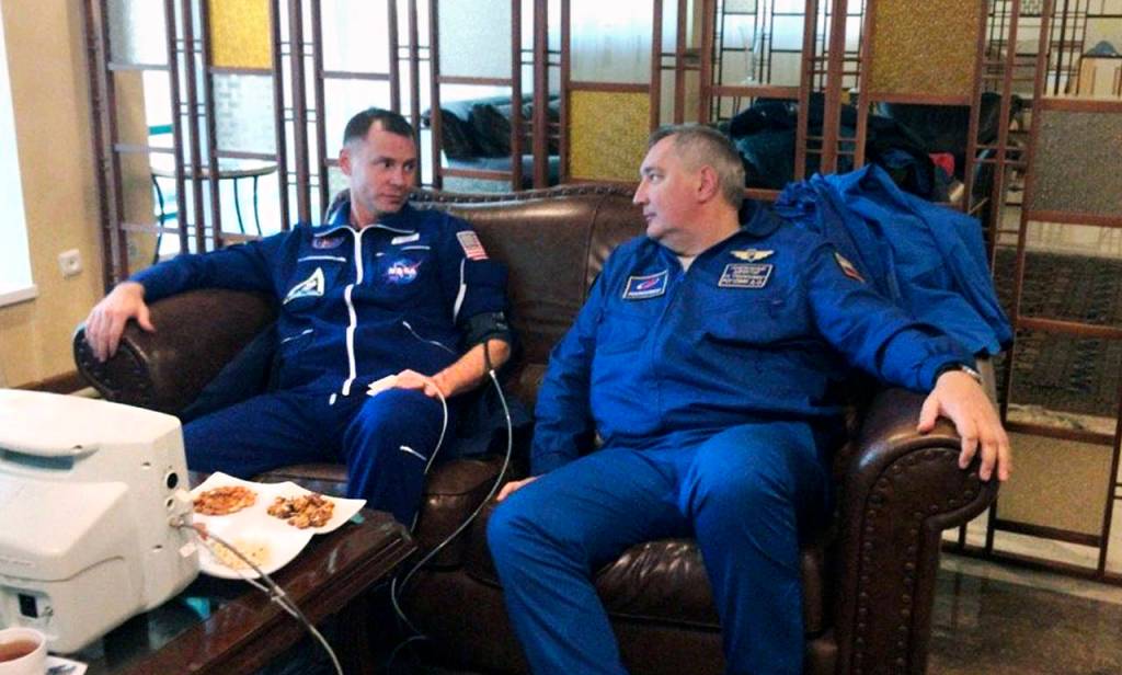 NASA Astronaut Nick Hague (left) and Roscosmos Director Dmitry Rogozin sit in Dzhezkazgan, Kazakhstan on Thursday after an emergency landing following the failure of a Russian booster rocket carrying them to the International Space Station. (Roscosmos via AP)