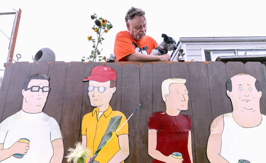 Kelly Hatley, 63, proudly displays characters from King of the Hill in Freeland on Whidbey Island. (Kevin Clark / The Herald)