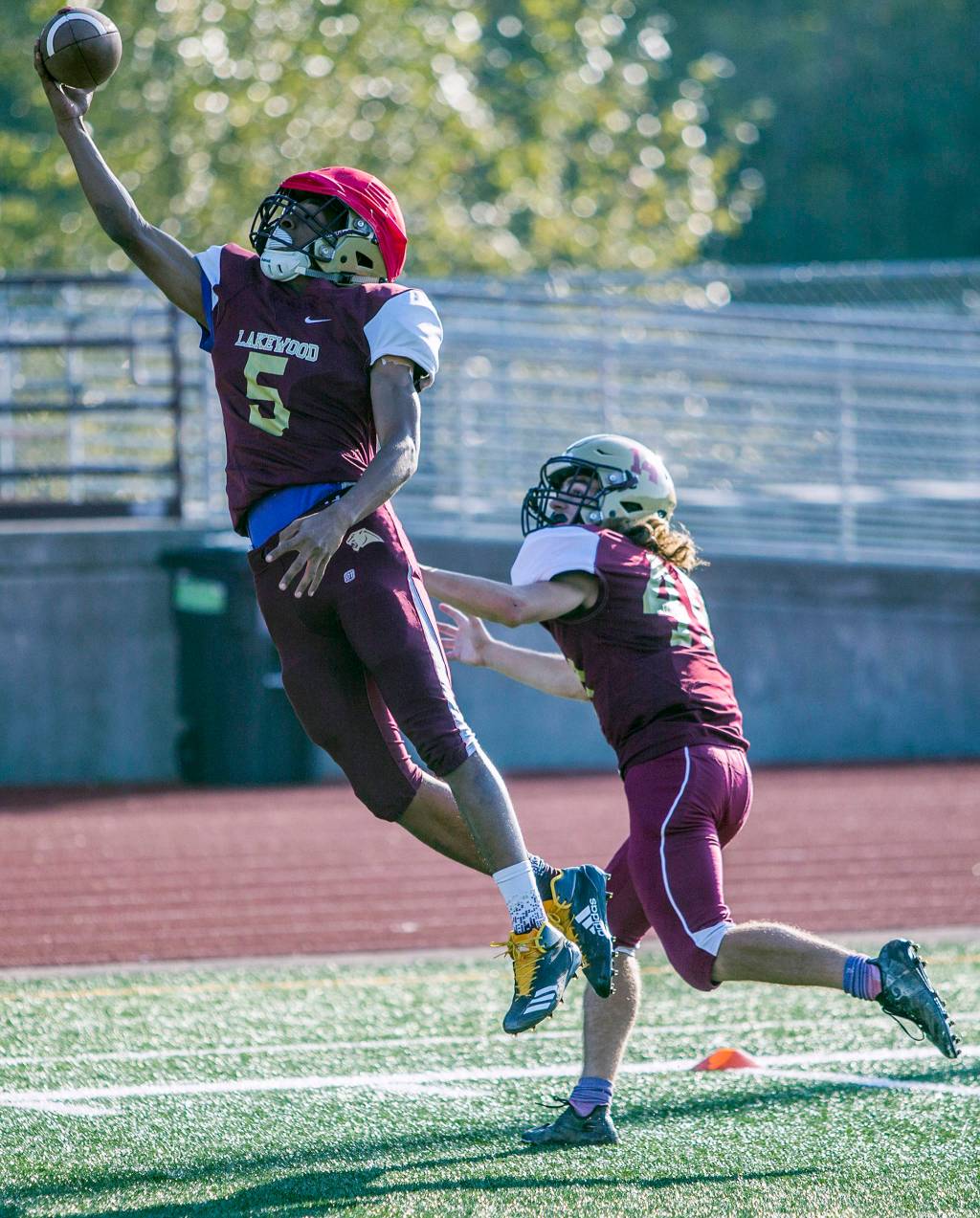 Machai Harris jumps to catch a pass during football practice at Lakewood High School on Oct. 10 in Arlington. (Olivia Vanni / The Herald)