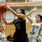 Lake Stevens Raigan Reed (22) goes to the hoop as shes pursued by Glacier Peaks Samantha Fatkin (5) during the Class 4A District 1 girls basketball championship game at Everett Community College on Thursday, Feb. 16, 2017. (Ian Terry / The Herald)