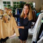 Anna Marie Laurence holds up an outfit that belonged to her mother, Helen Jackson, whose favorite color was yellow. (Dan Bates / The Herald)