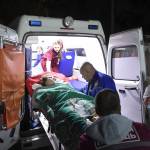 Medics load an injured person onto an ambulance Wednesday in Kerch, Crimea. Russian officials says an 18-year-old student attacked his vocational school in Crimea, going on a rampage that killed 19 students and left more than 40 people wounded before killing himself. (Viktor Korotaev/Kommersant Photo via AP)