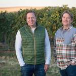 Scott Haladay (left) and his family purchased Walla Walla Vintners in 2017 and talented winemaker William vonMetzger (right) remains in the cellar of the iconic red barn. (Photo courtesy of Walla Walla Vintners)