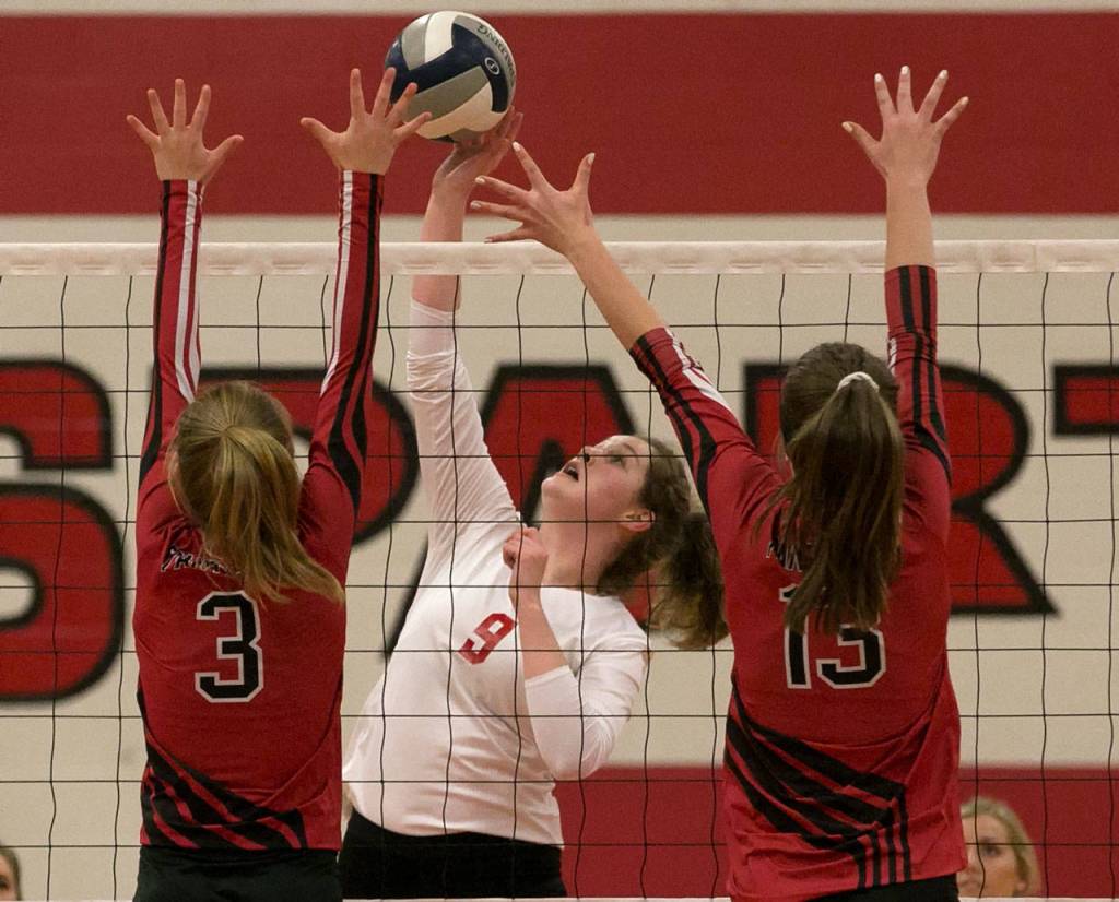 Stanwoods Jordyn Foxen (center) attempts a kill with Snohomishs Natalie Stern (left) and MacKenzie Whyte blocking Thursday at Stanwood High School. (Kevin Clark / The Herald)