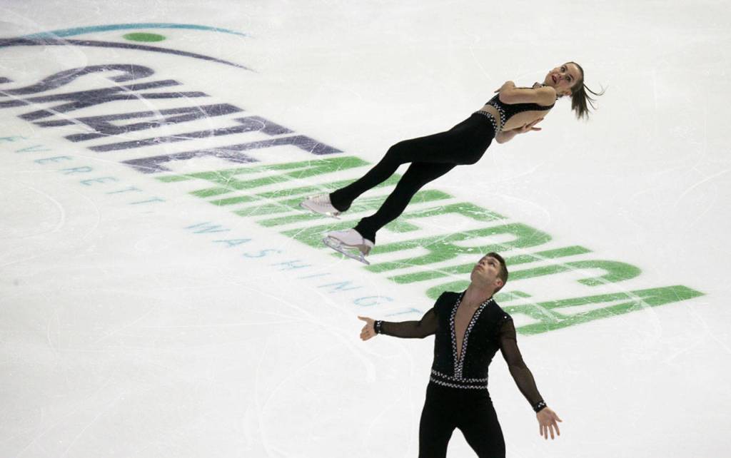 Evelyn Walsh is thrown by Trennt Michaud of Canada during the pairs short program at the 2018 Skate America competition Friday at Angel of the Winds Arena in Everett. The 2018 Skate America is the first event in the 2018 ISU Grand Prix of Figure Skating Series. (Andy Bronson / The Herald)