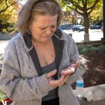 Adrienne Wurts looks at her scarred hands as she tells the story of the day she was attacked and stabbed by David Dario Lucius outside the Walton Post Office last month. (Andy Nelson / The Register-Guard)