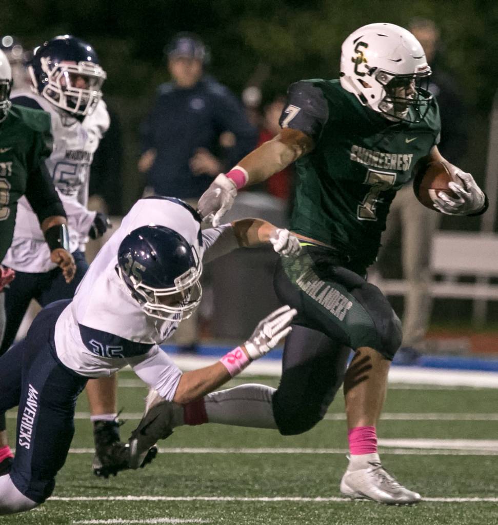 Shorecrests Markus Selzler avoids a tackle by Meadowdales Mason Vaughn at Shoreline Stadium on Oct. 12. (Kevin Clark / The Herald)