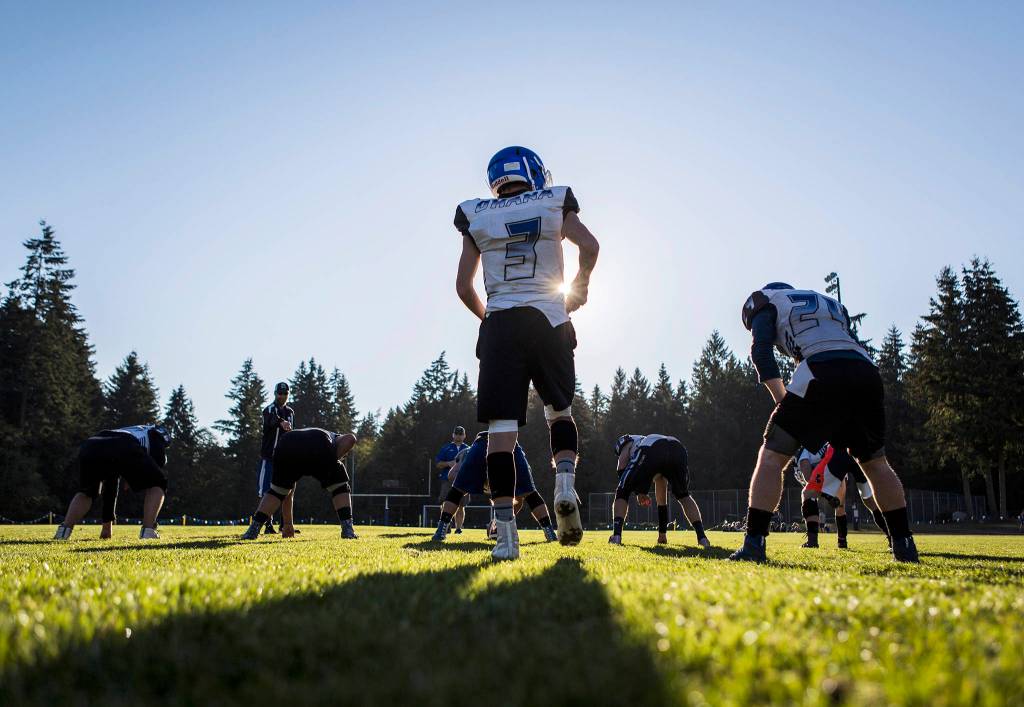 Kody Newman prepares for the snap during football practice at South Whidbey High School on Oct. 16 in Langley. (Olivia Vanni / The Herald)