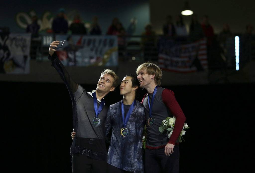 The medal winners of the men free skating program, Sergei Vornov, Nathan Chen and Michal Brezina, take a selfie on the podium at the 2018 Skate America competition on Saturday at Angel of the Winds Arena in Everett. (Olivia Vanni / The Herald)