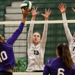 Kamiaks Quinci Flowers (left) hits the ball at the net as Jacksons Ainsley Johanson (13) and Paige Wilson leap to make the block during a Wesco 4A match Tuesday at Jackson High School in Mill Creek. (Kevin Clark / The Herald)