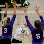 Jacksons Ainsley Johanson (center) hits a ball at the net as Kamiaks Hannah Knutt (left) and Grace Forster (right) leap to make the block during a Wesco 4A match Tuesday at Jackson High School in Mill Creek. (Kevin Clark / The Herald)