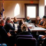 Rabbi Rachel Kort (far end, left) and the Rev. Carol Jenson lead discussion at a gathering at Everetts Temple Beth Or Monday to talk about a vigil in response to the weekends horrific killings in Pittsburgh. The meeting drew a good number of participants, including from area faith groups. (Dan Bates / The Herald)