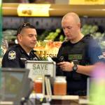 Members of the Louisville Metro Police Department talk inside a Kroger grocery in Jeffersontown, Kentucky, following a shooting that left two people dead Wednesday. (AP Photo/Timothy D. Easley)