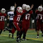 Snohomishs Tayte Conover (18) throws up his arms after scoring on a quarterback keeper during the Panthers 30-27 win over Squalicum on Fridayat Veterans Memorial Stadium in Snohomish. (Andy Bronson / The Herald)